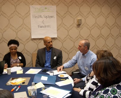 Michael O. Royster, MD, MPH, FACPM, Vice President of the Institute for Public Health Innovation (center) leads a Global Cafe discussion.