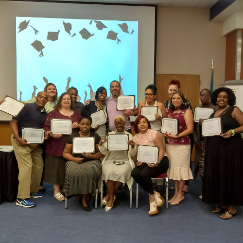 Community health workers (CHWs) celebrating with their certificates after completing a CHW training.