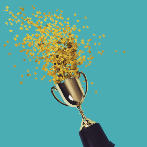 Star confetti popping out of a gold trophy.