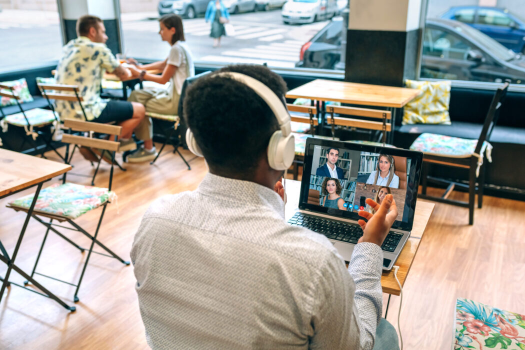 Man working by video call from a cafeteria Unrecognizable man working by video call from a cafeteria