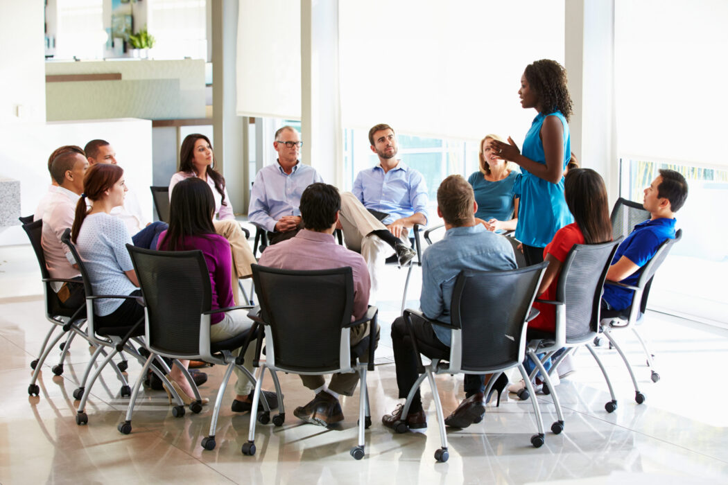 Businesswoman Addressing Multi-Cultural Office Staff Meeting Businesswoman Addressing Multi-Cultural Office Staff Meeting